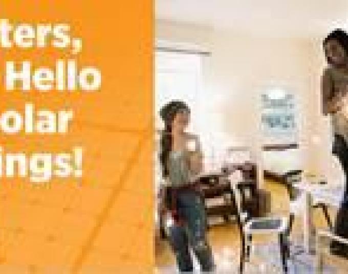 Three young women hanging a string of light in the living room. Orange background with LADWP logo and white letters that read: Renters, Say Hello to Solar Savings!